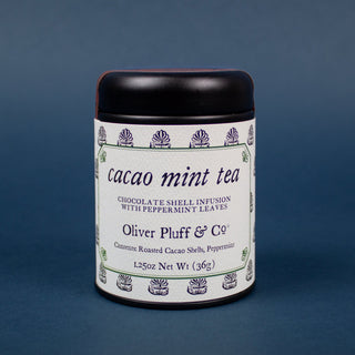 front image of small black tin that holds cacao. 1.25 oz net weight