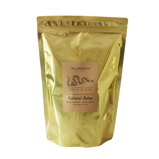 Gold bag of tea with a label on a white background