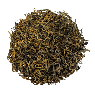Dry black tea leaves with a golden color on a white background